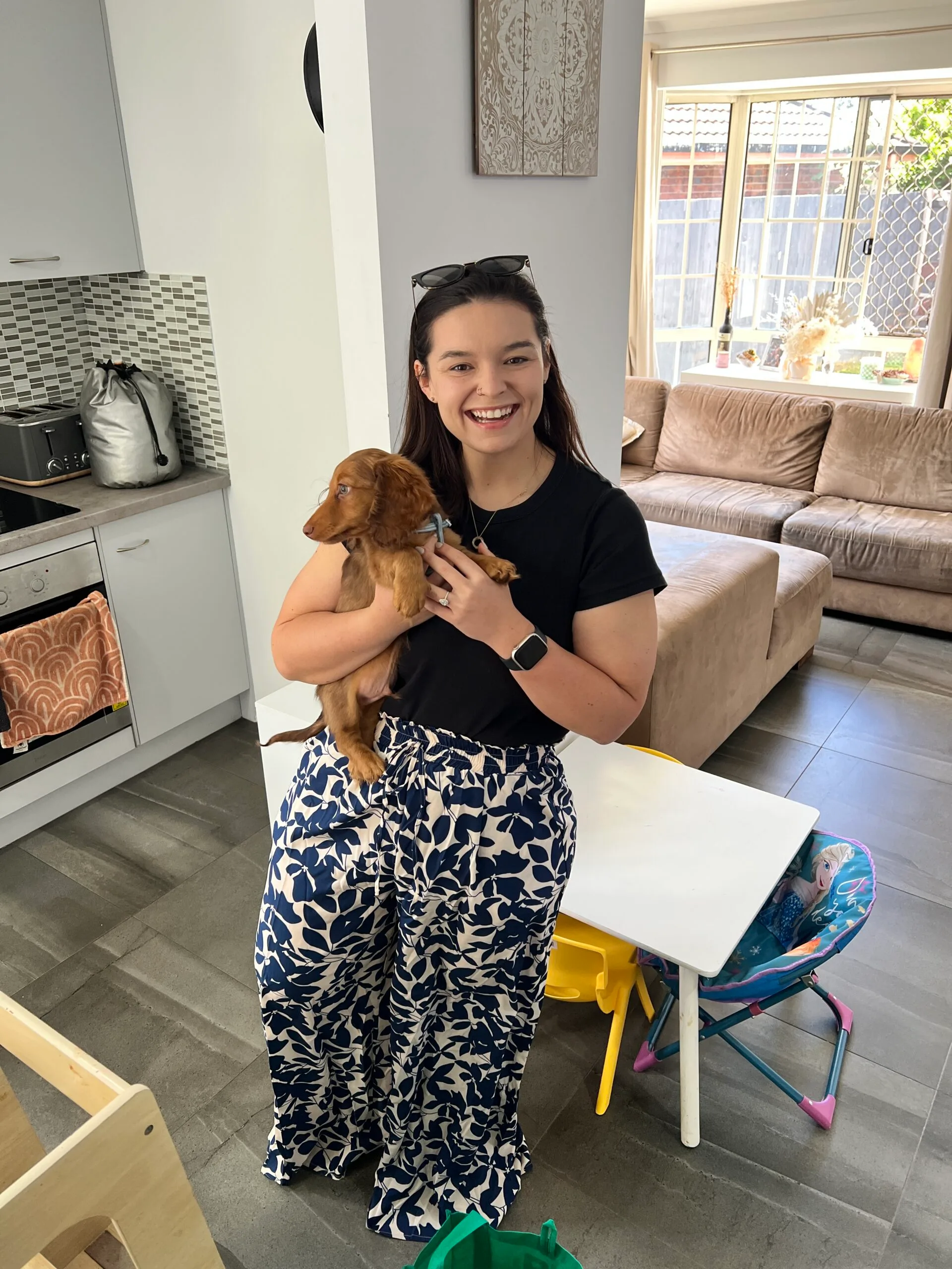 woman holding sausage dog