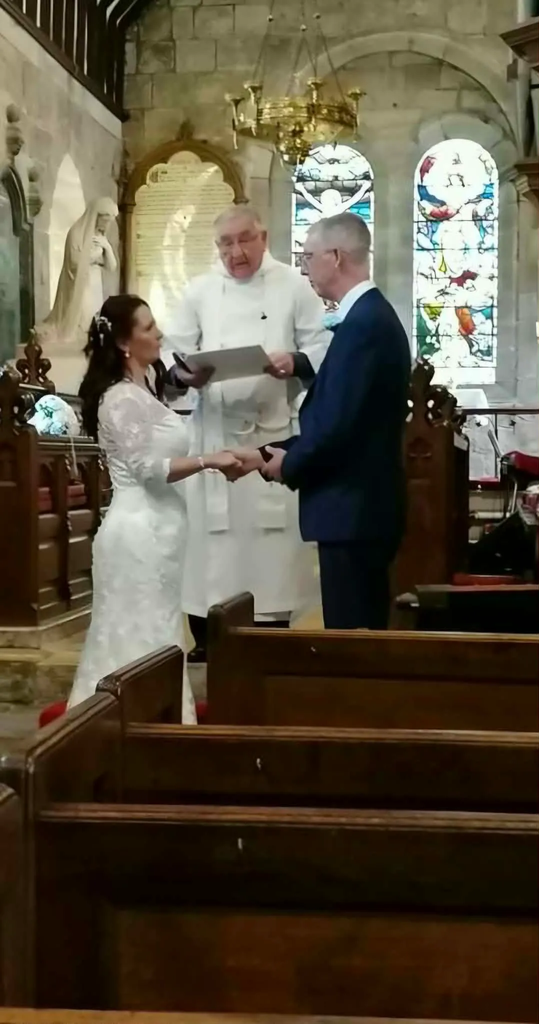 Image of bride and groom at the altar