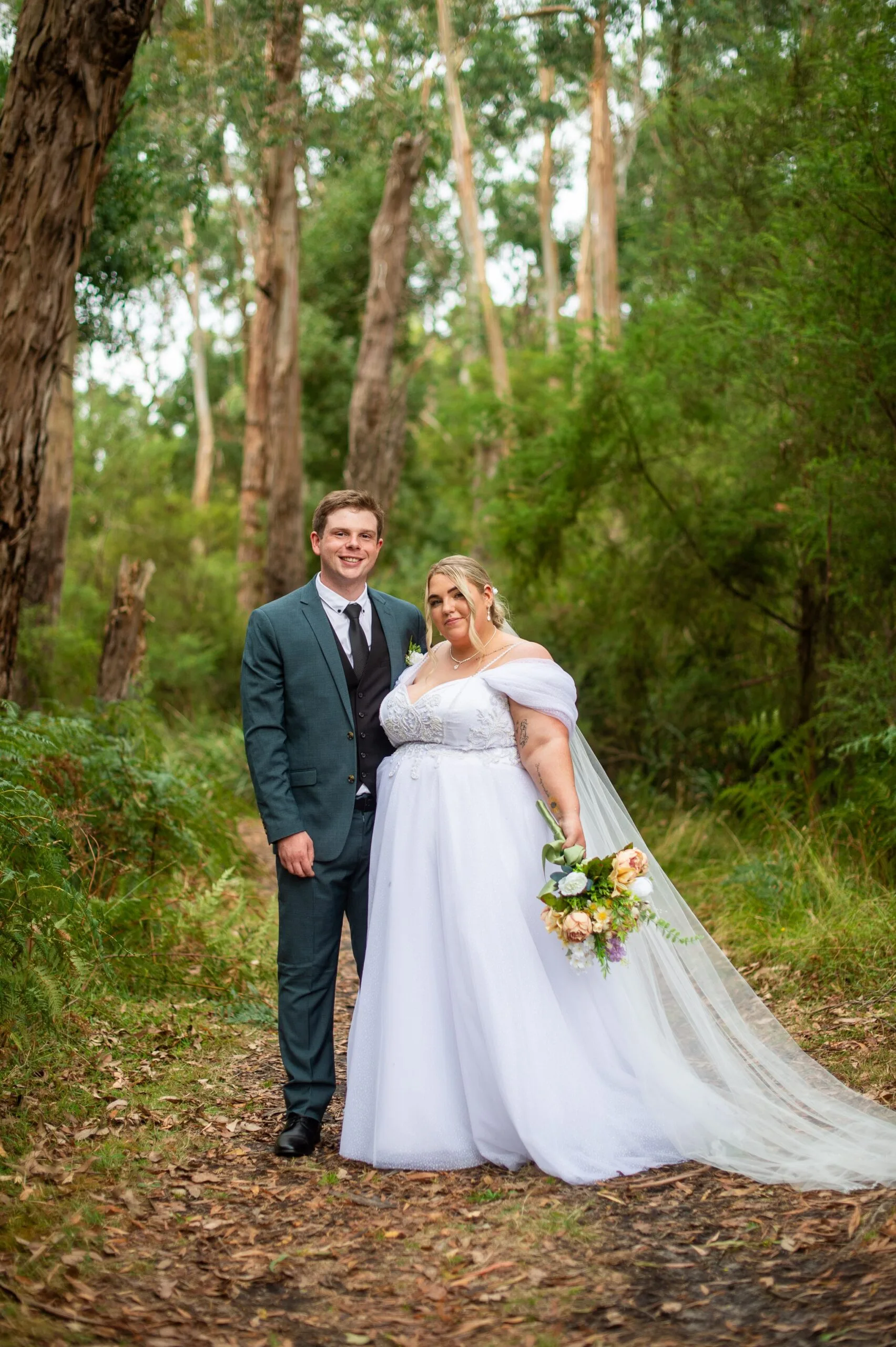 bride and groom pose in trees