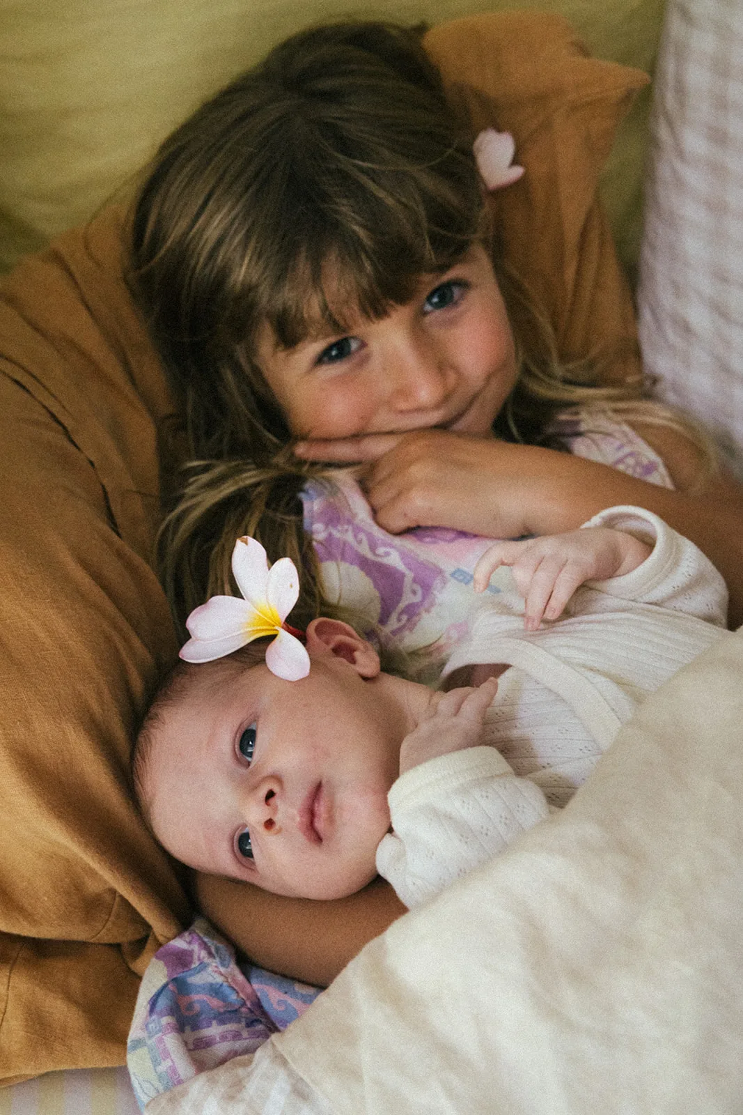 young girl holding baby 