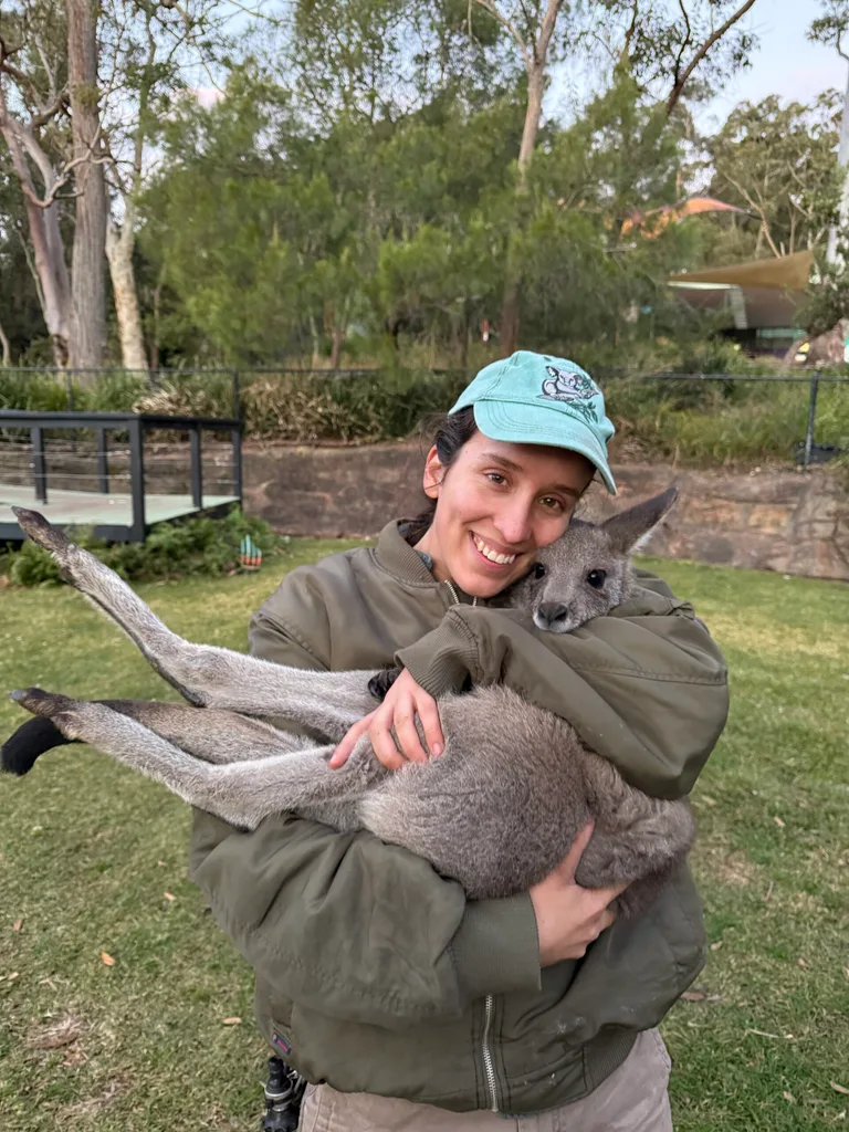 Image of zoo keeper with kangaroo joey