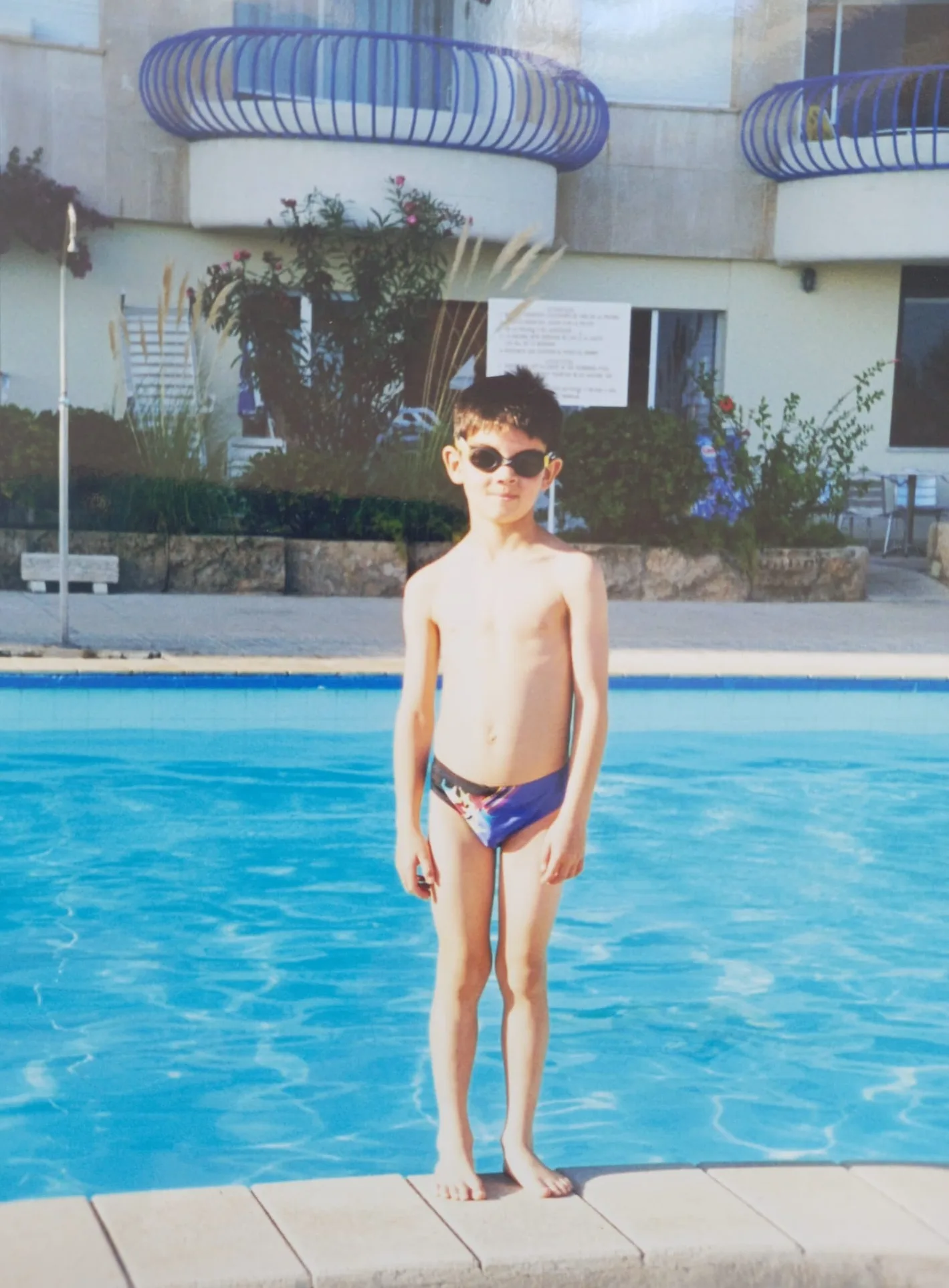 kid beside swimming pool