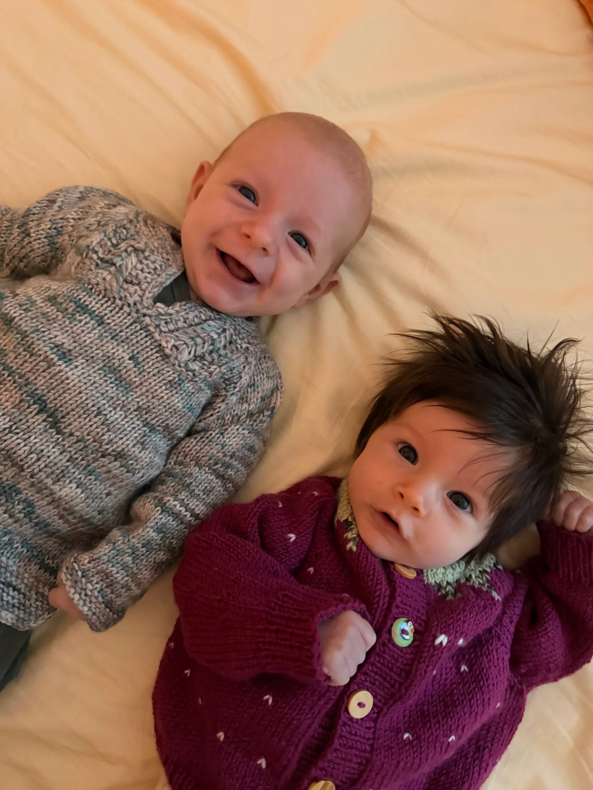 two babies in knitted jumpers
