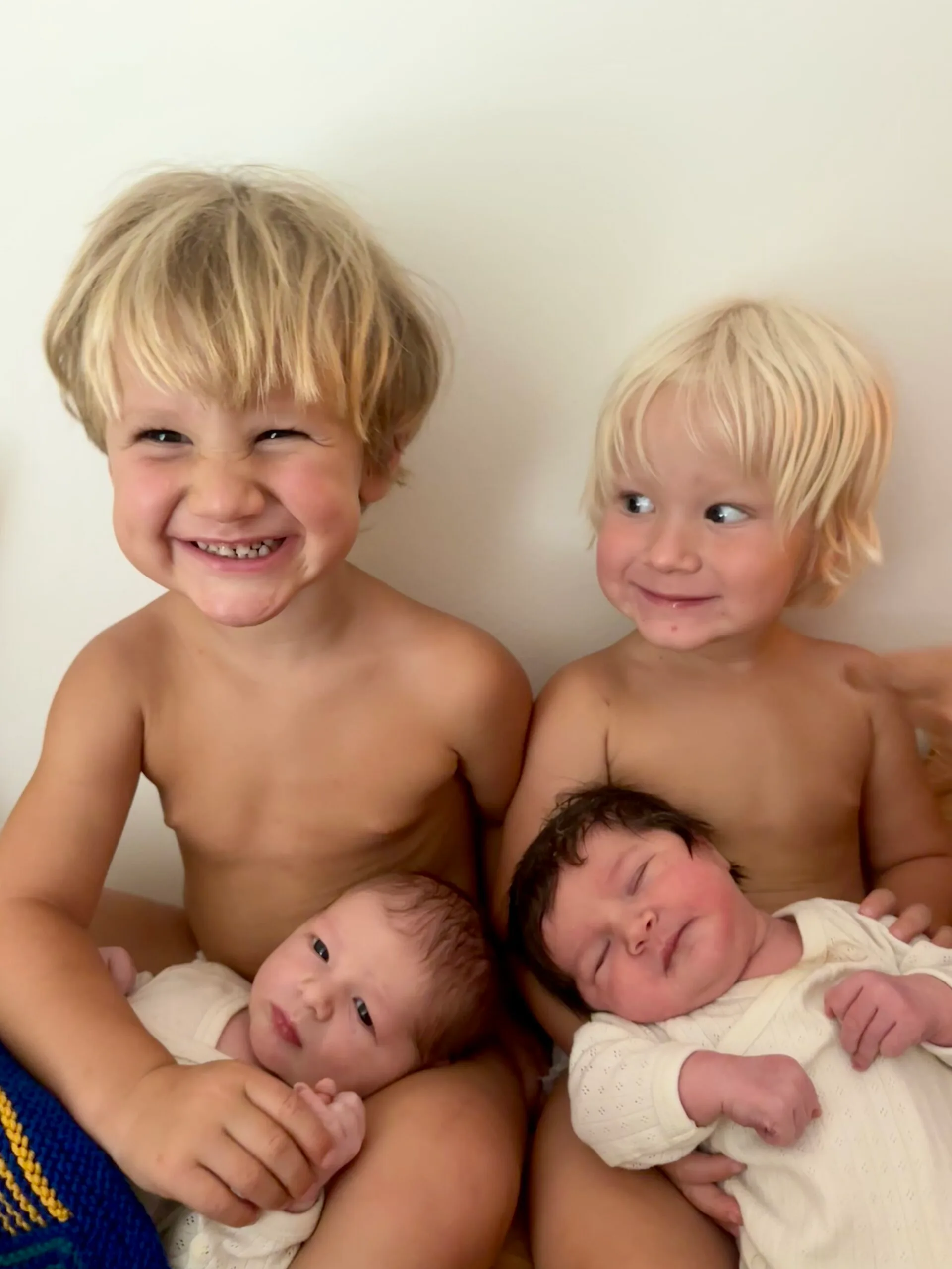 older siblings holding baby siblings