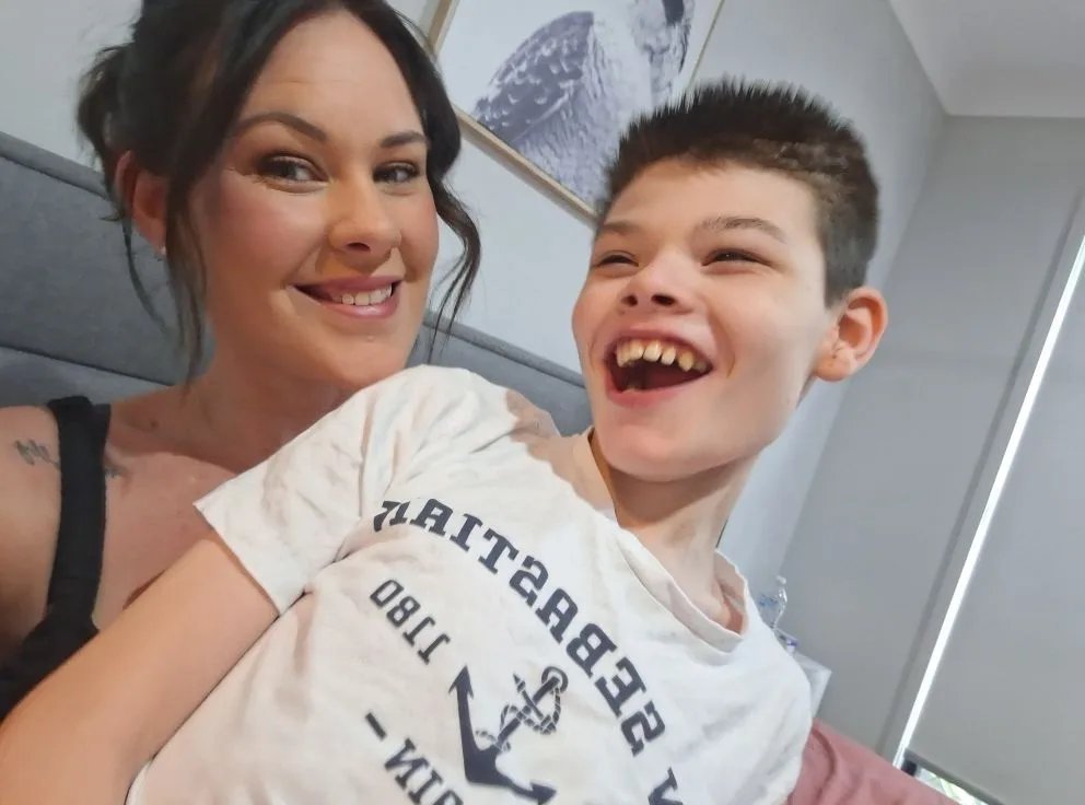 mother and son smiling for the camera