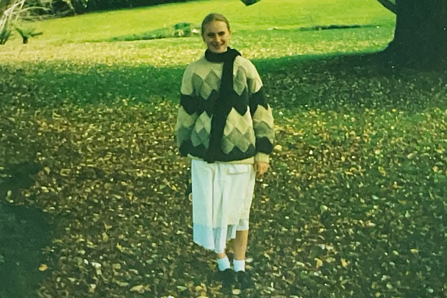 Teenaged girl in the 1990s stands on a lawn