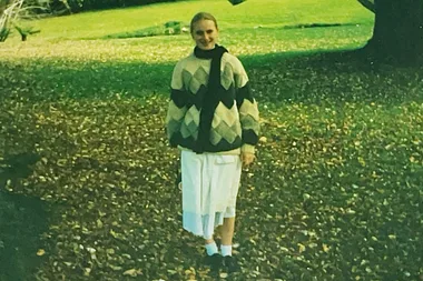 Teenaged girl in the 1990s stands on a lawn