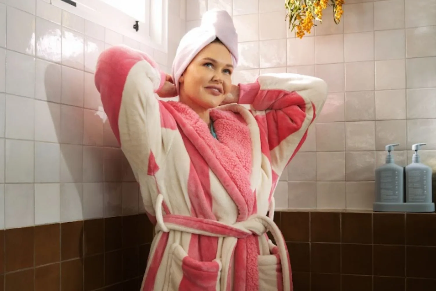 Woman in dressing gown in bathroom