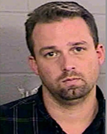 man in plaid shirt mugshot