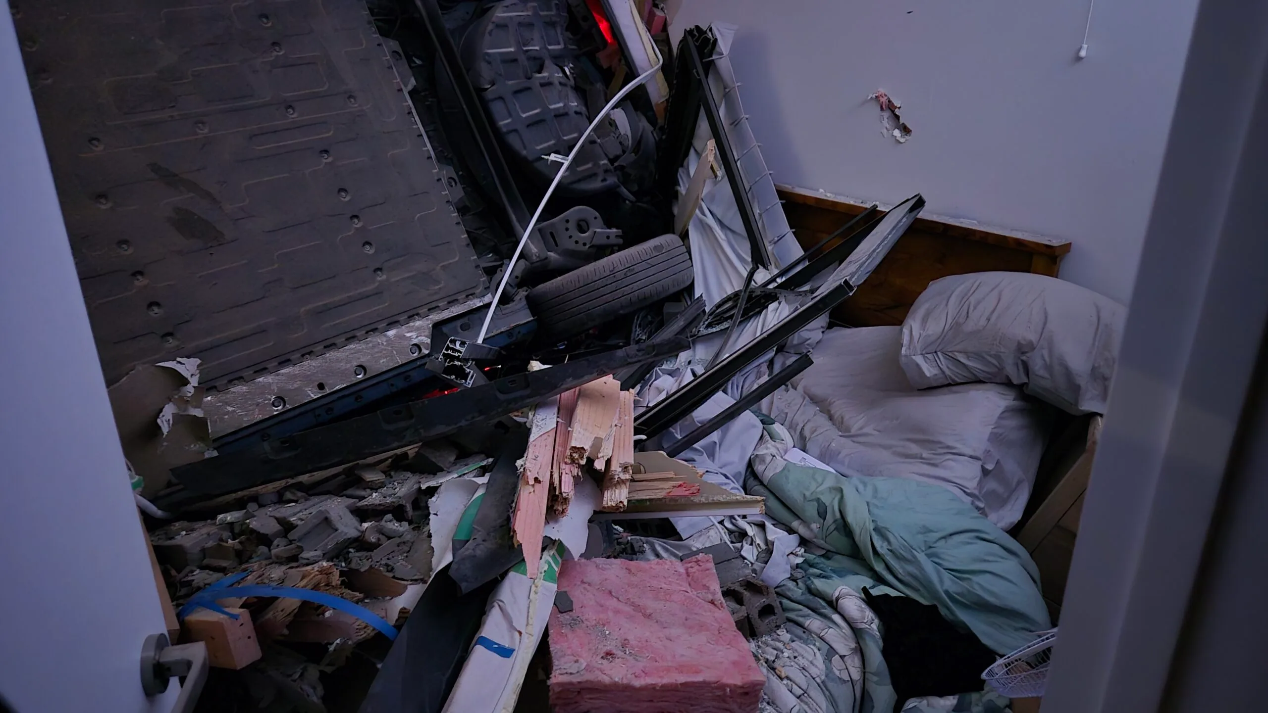 a car on it's side in the bedroom