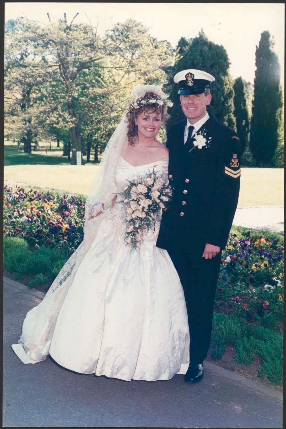 woman and man on wedding day, man is in navy uniform