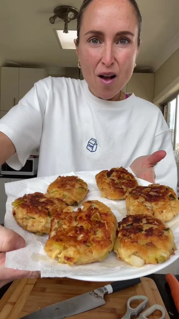 woman holding fritters towards camera
