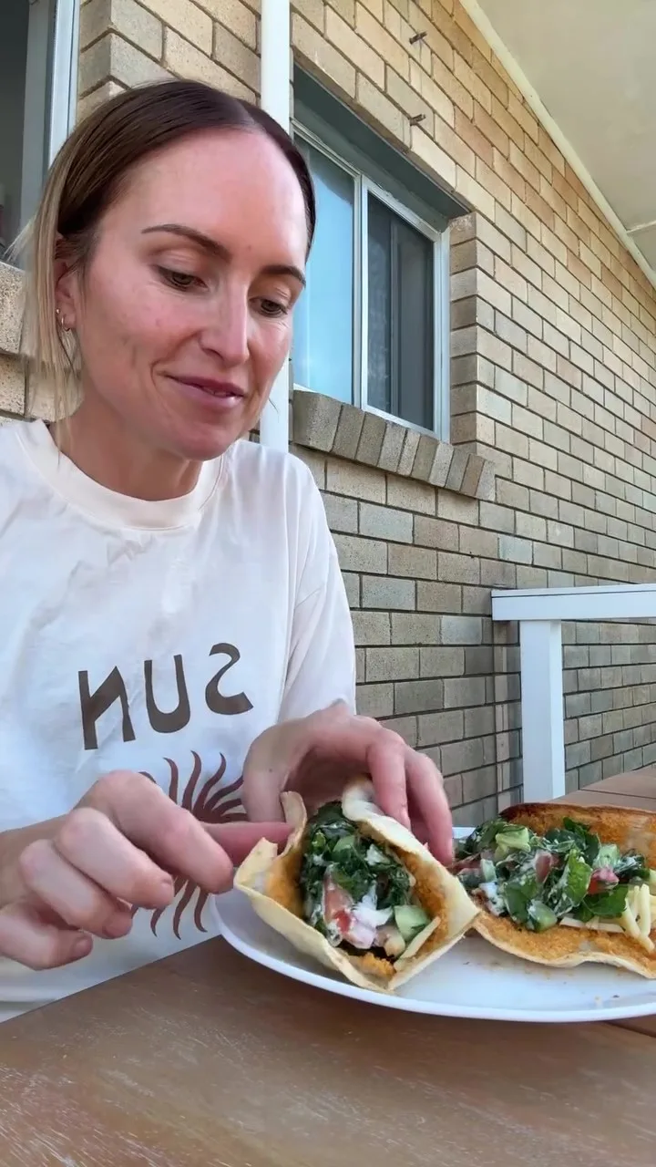 woman with plate of tacos
