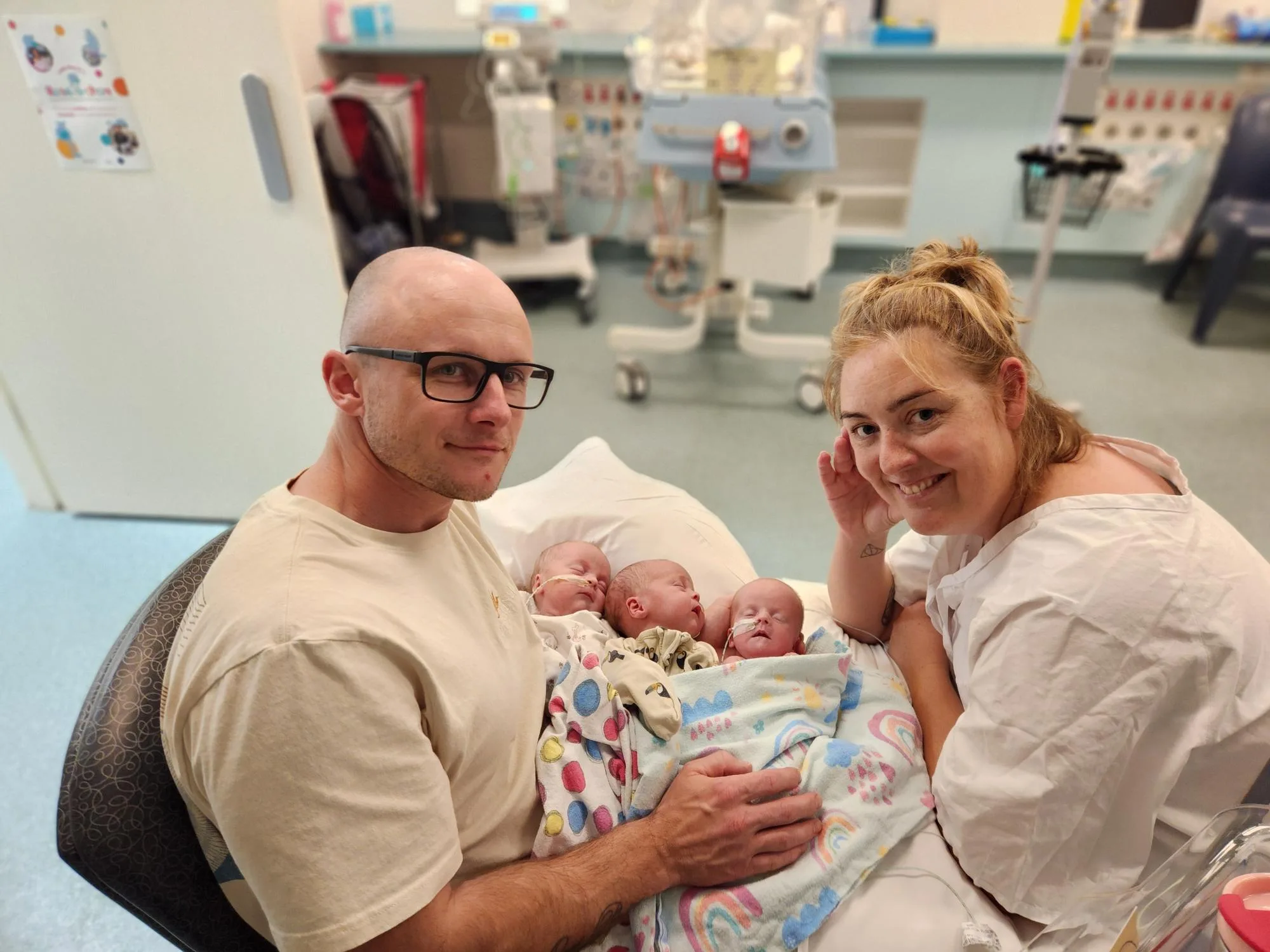 Image of Mum and dad with triplets in hospital