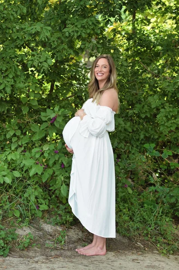Image of woman wearing white dress and pregnant with twins