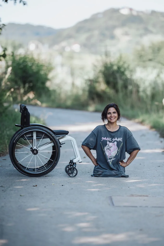 Image of woman amputee beside wheelchair