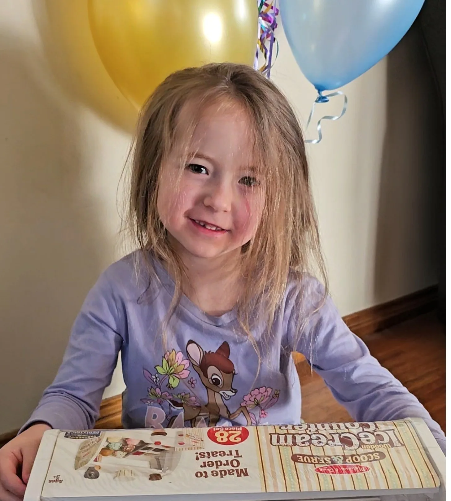 girl with balloons and gift