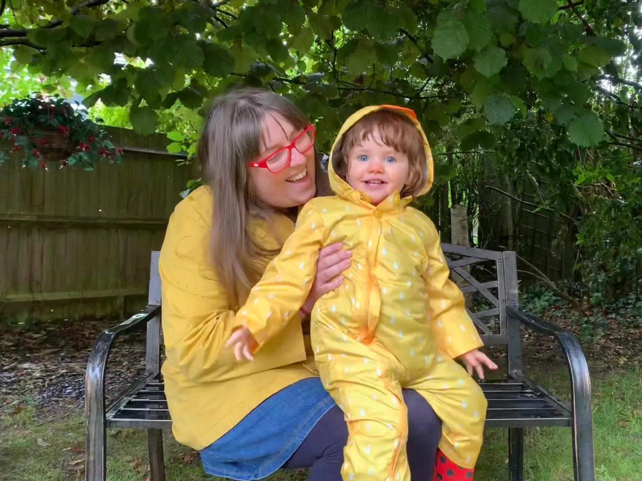 a girl and lady dressed in yellow raincoats