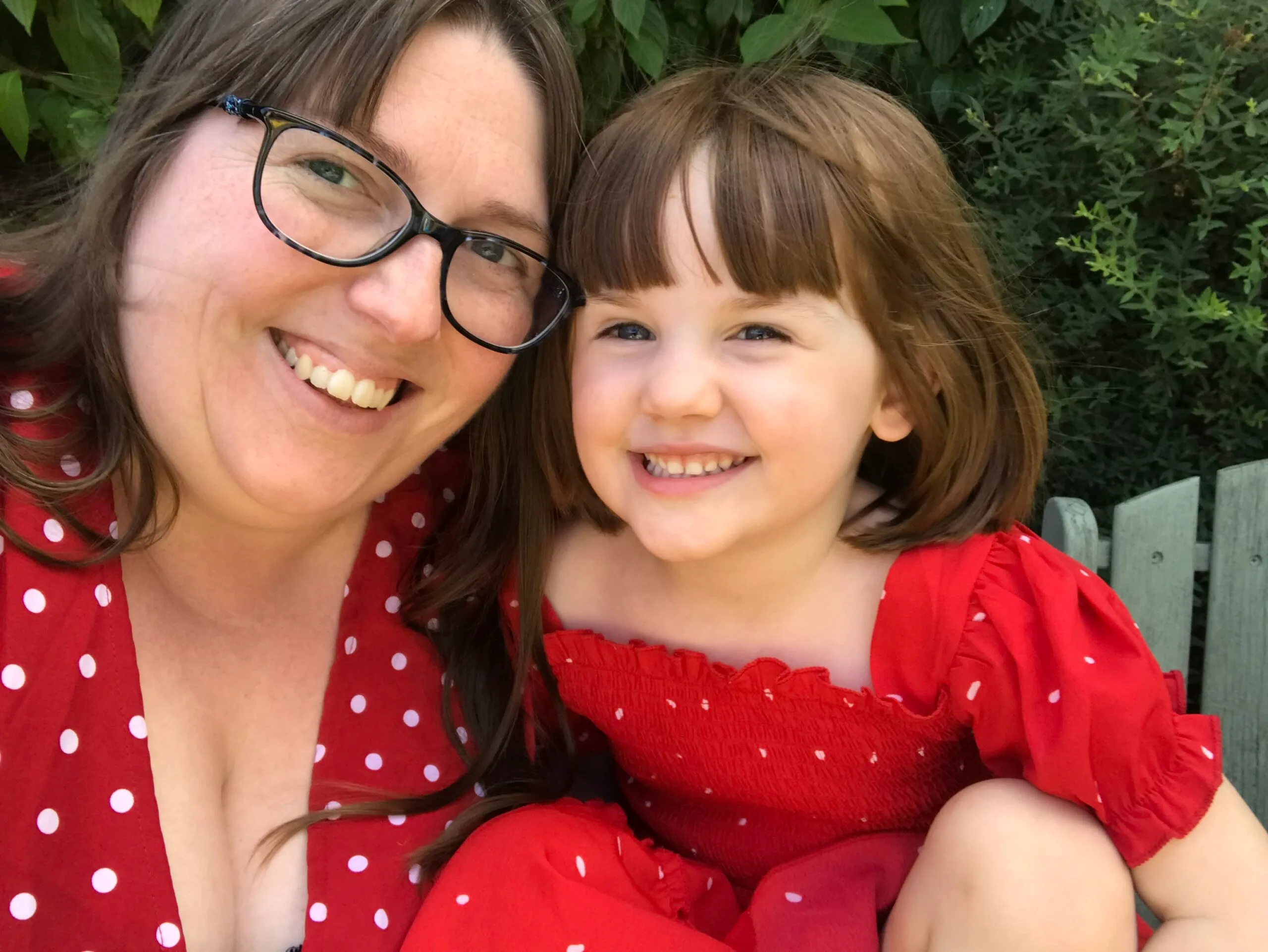 a woman and child dressed in red and white polka dots