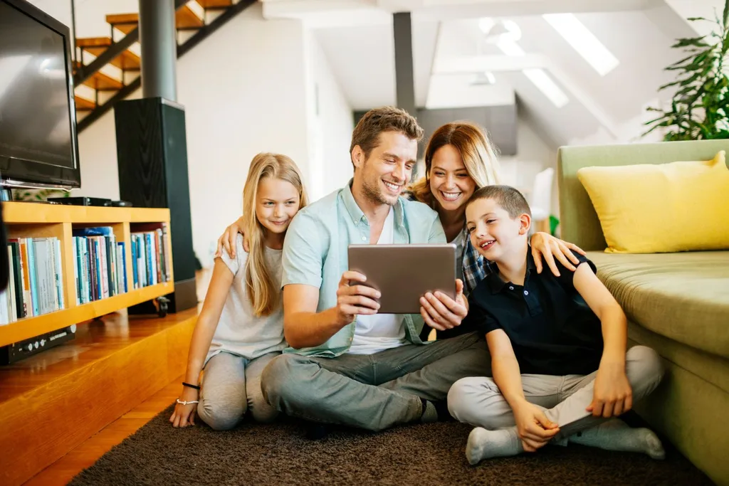 Family gathered around an ipad or tablet