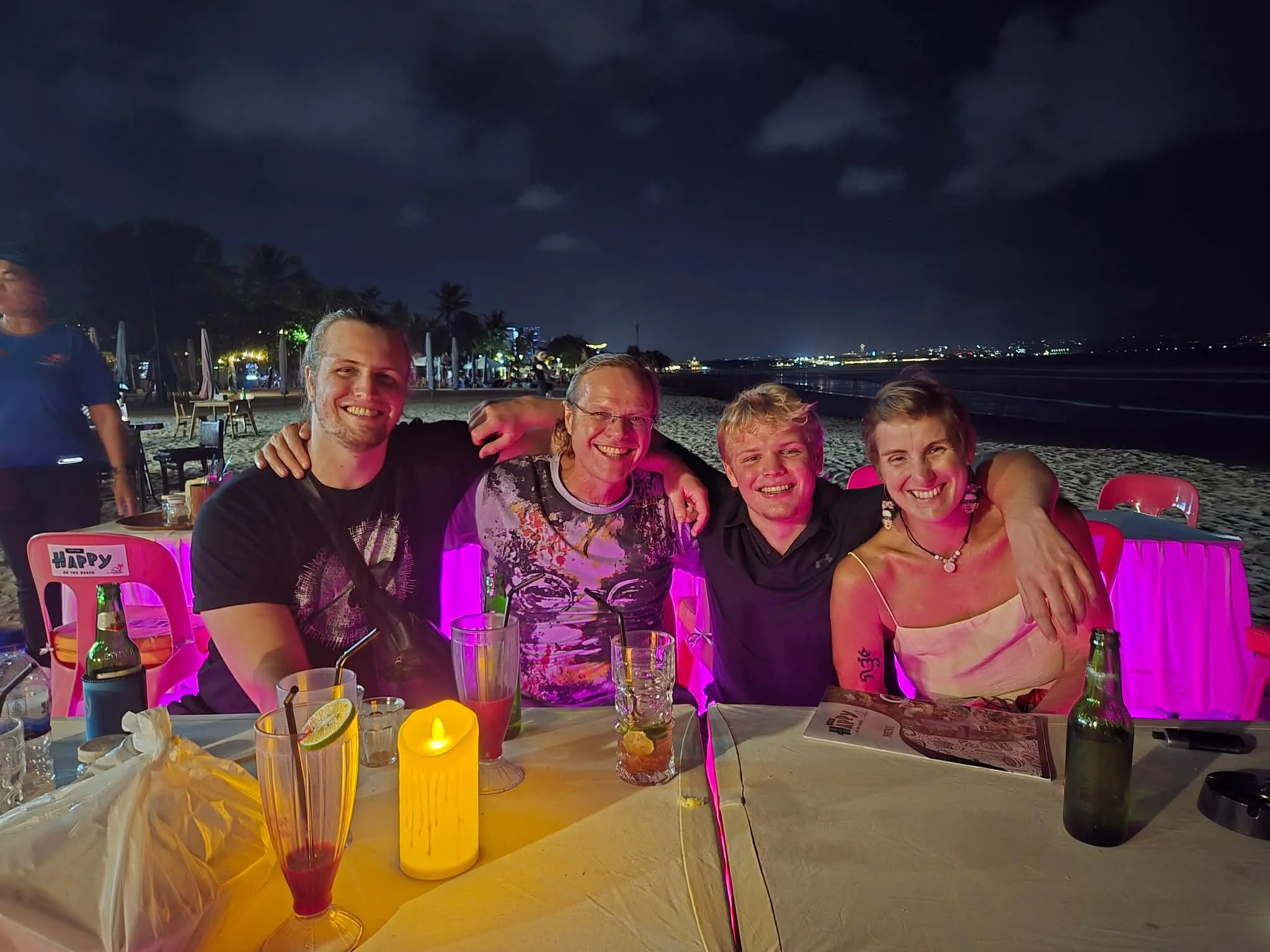 family eating dinner on the beach