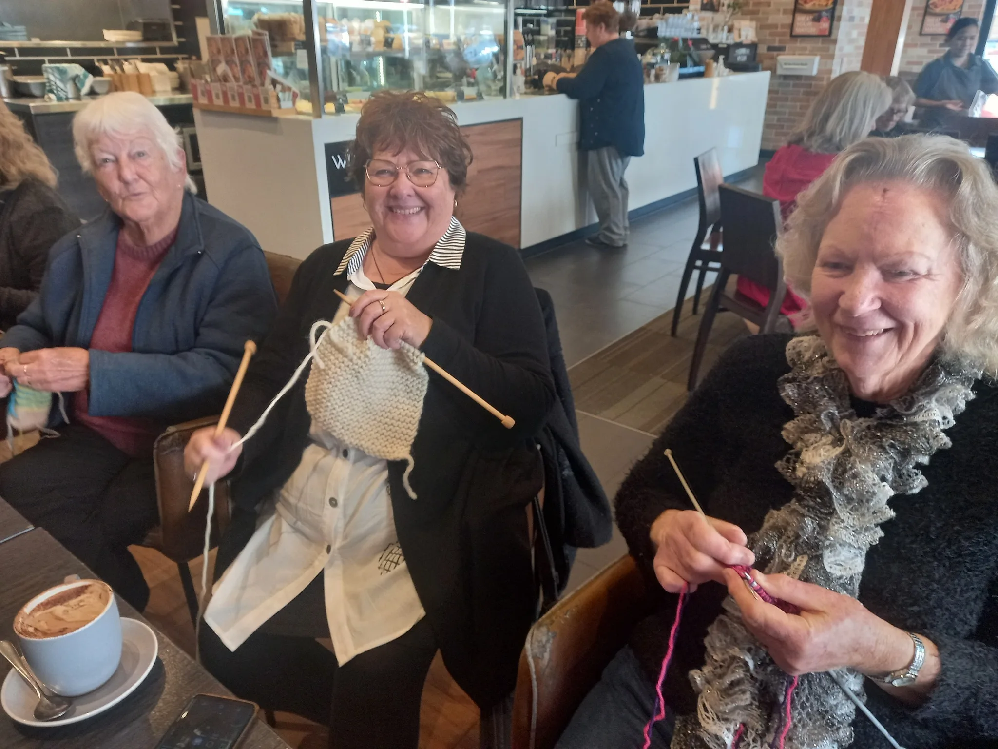 women knitting at table