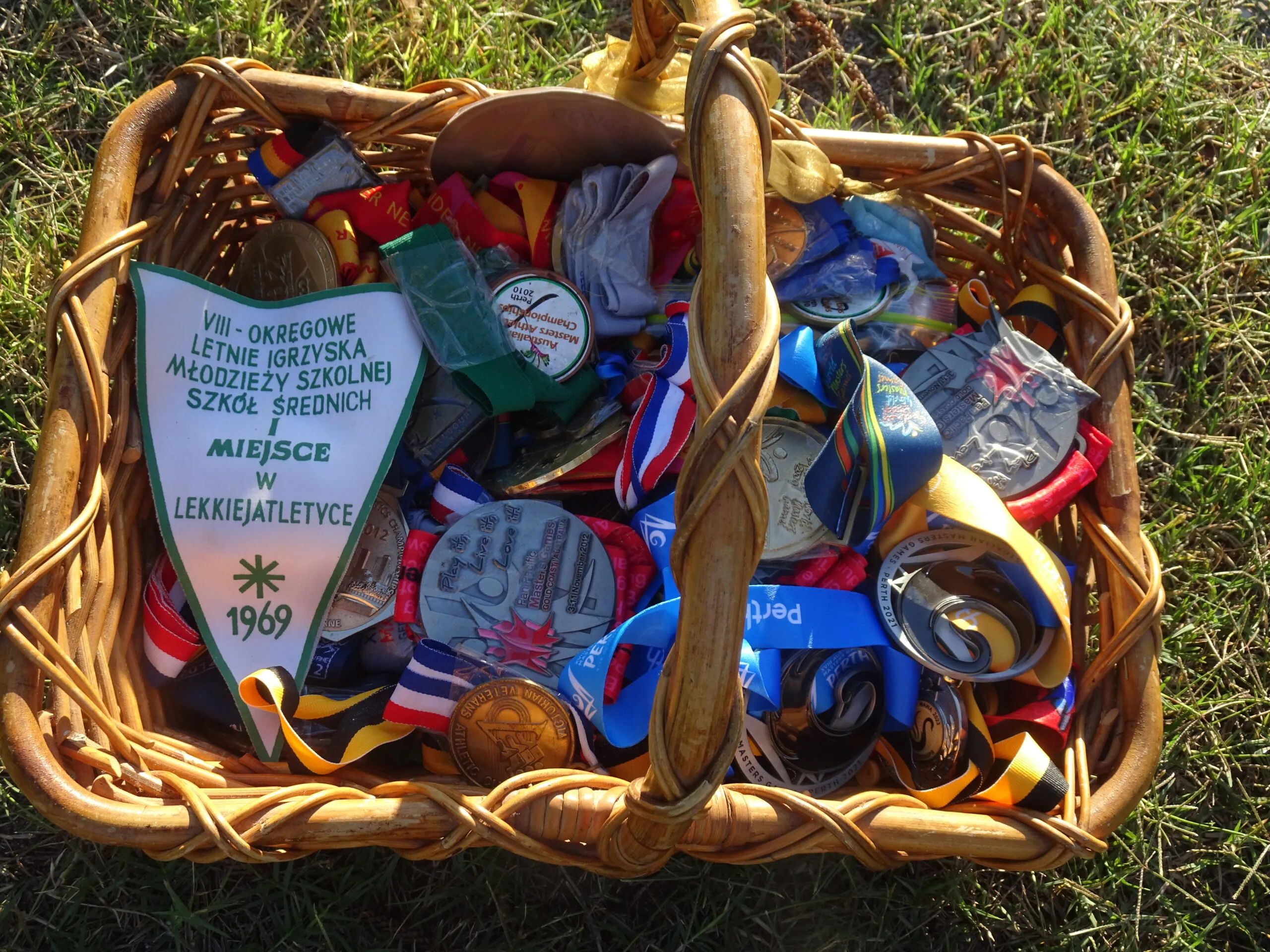 Basket of medals on the grass.