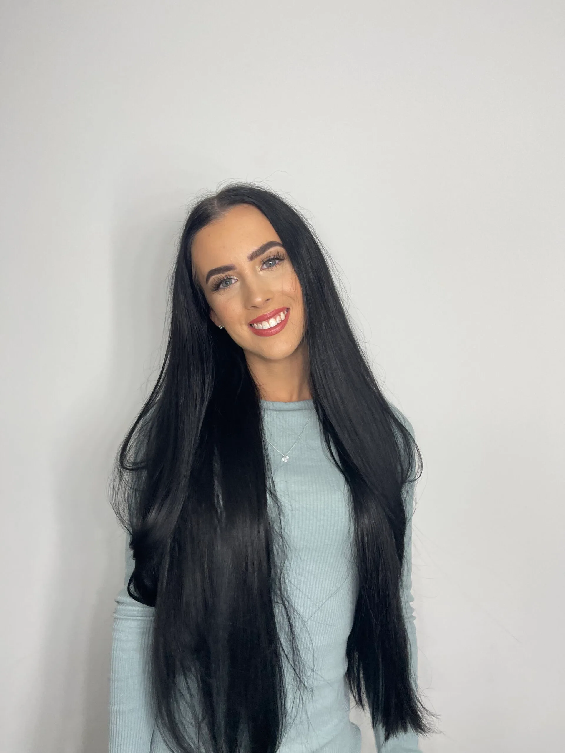 Image of woman smiling with long black hair