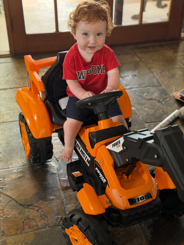 Image of young boy on ride on tractor
