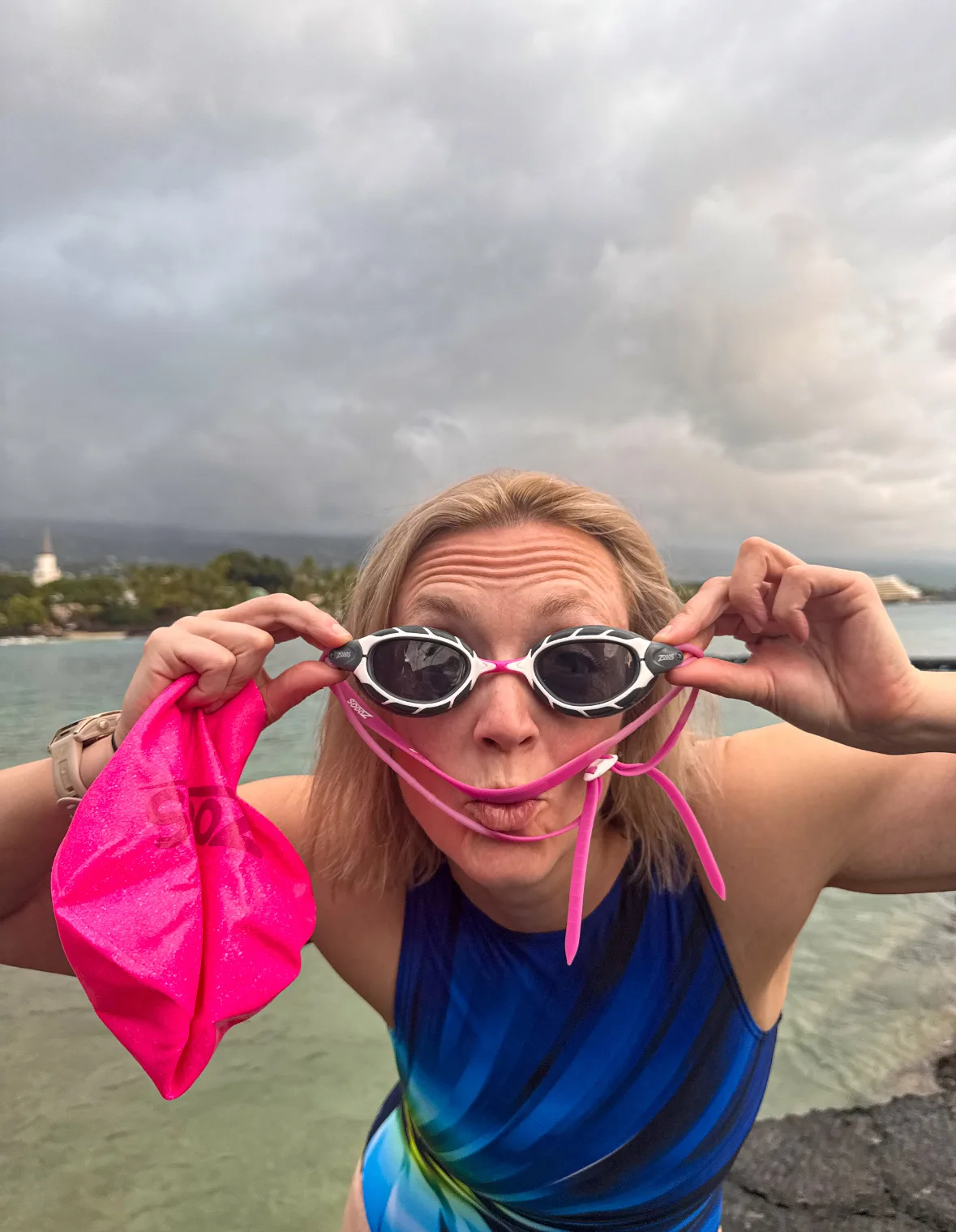 woman wearing goggles swimming