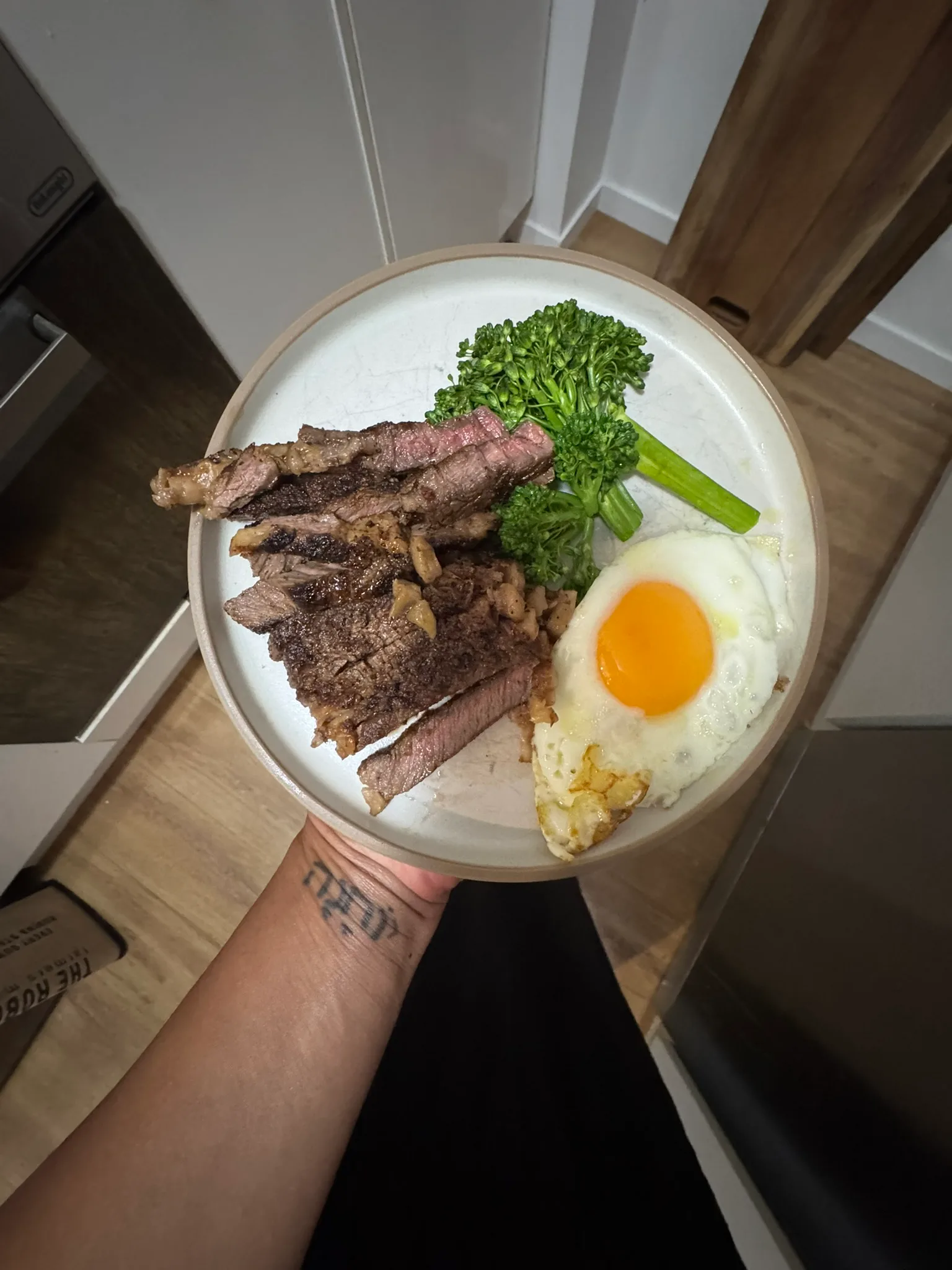 woman holding plate of steak 