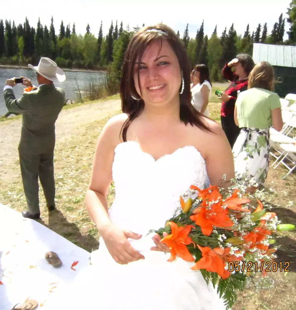 Image of woman on wedding day with orange flowers
