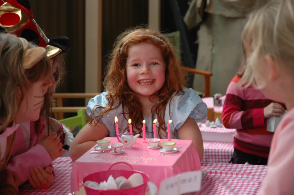 Image of young girl with her birthday cake