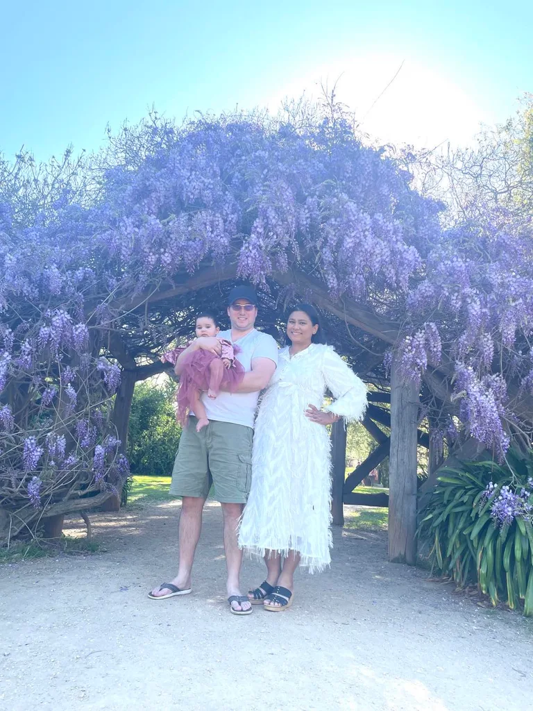 Image of parents and toddler with purple tree
