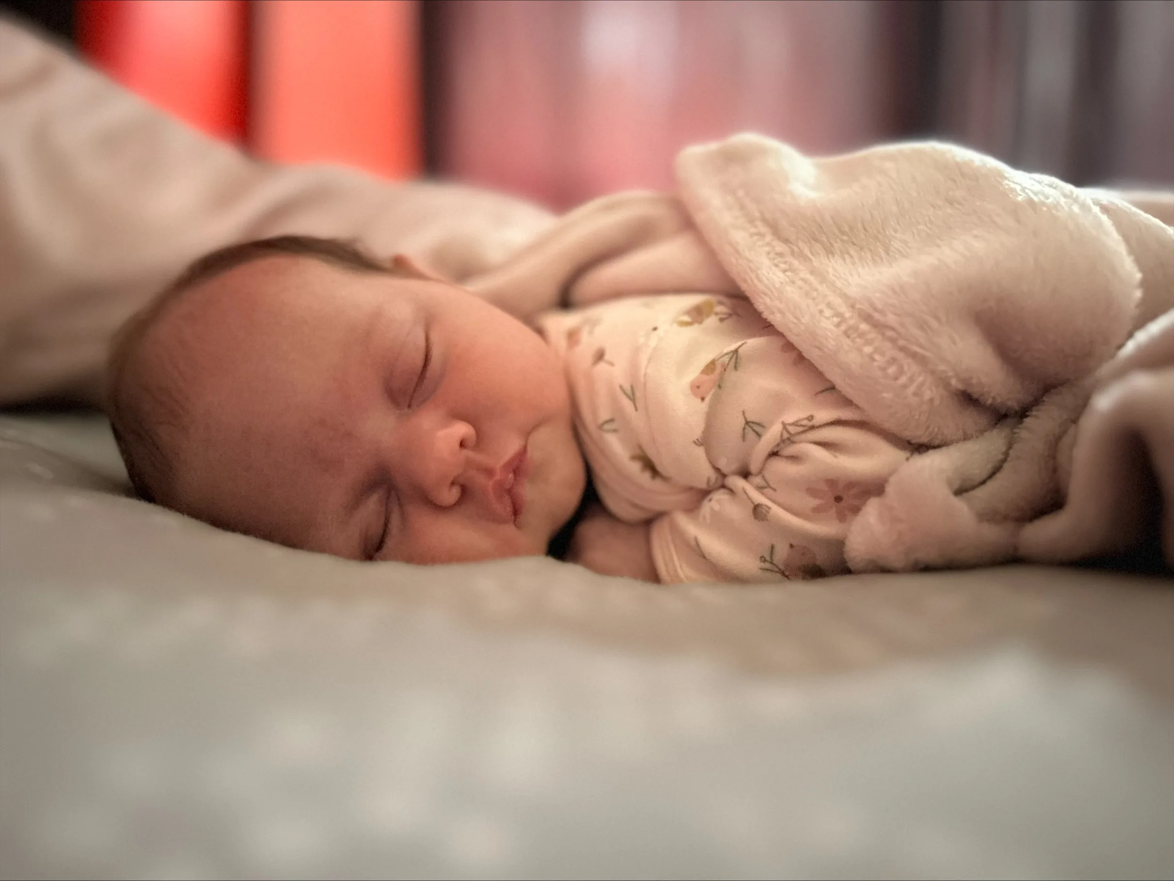 Newborn baby sleeping on bed. 
