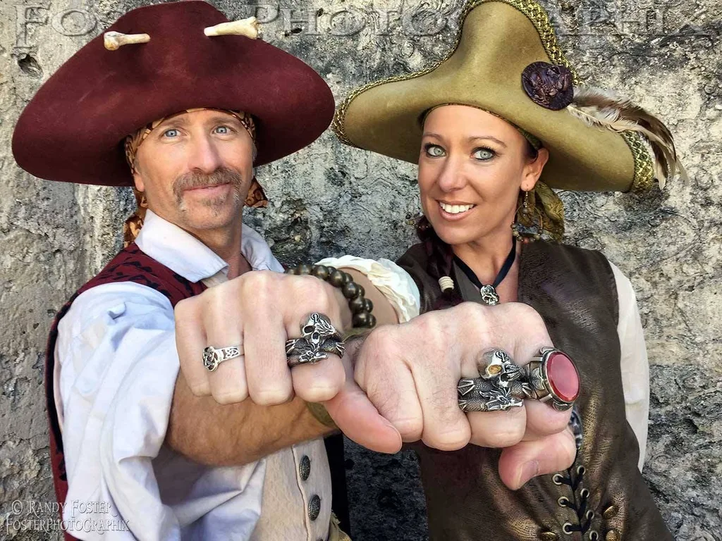 man and woman wearing pirate outfits