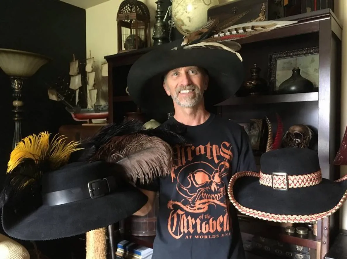 Man holding pirate hats