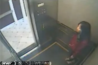 CCTV of woman standing in corner of lift