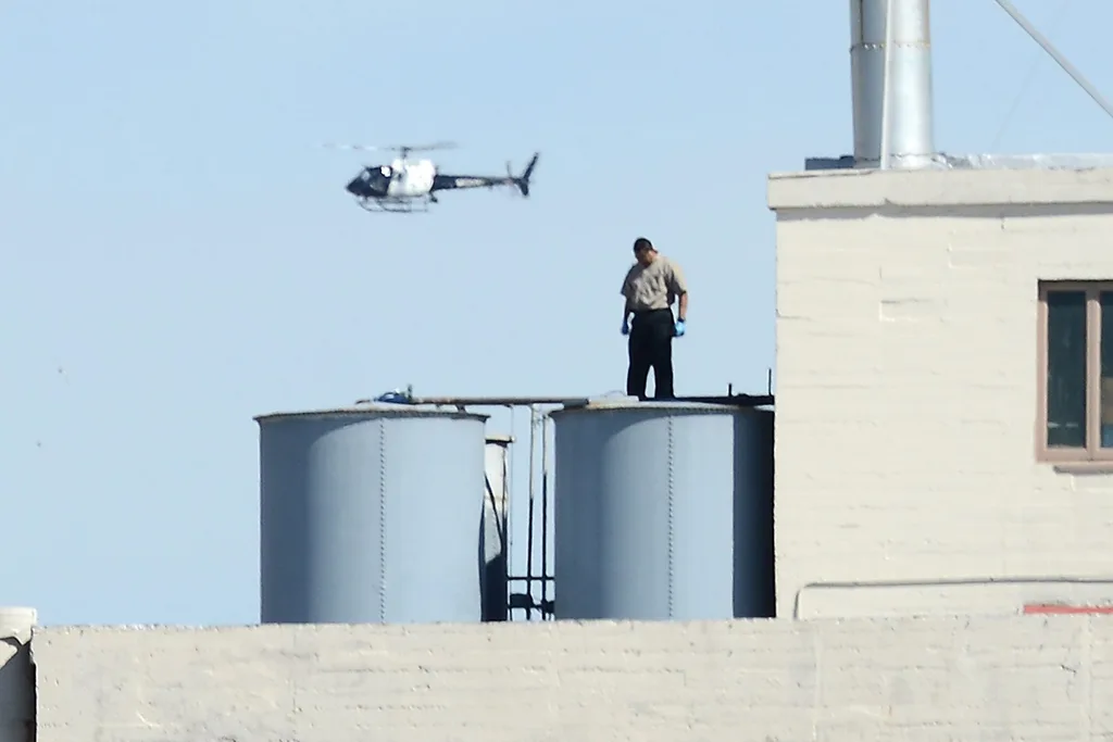 Man on rooftop water tank