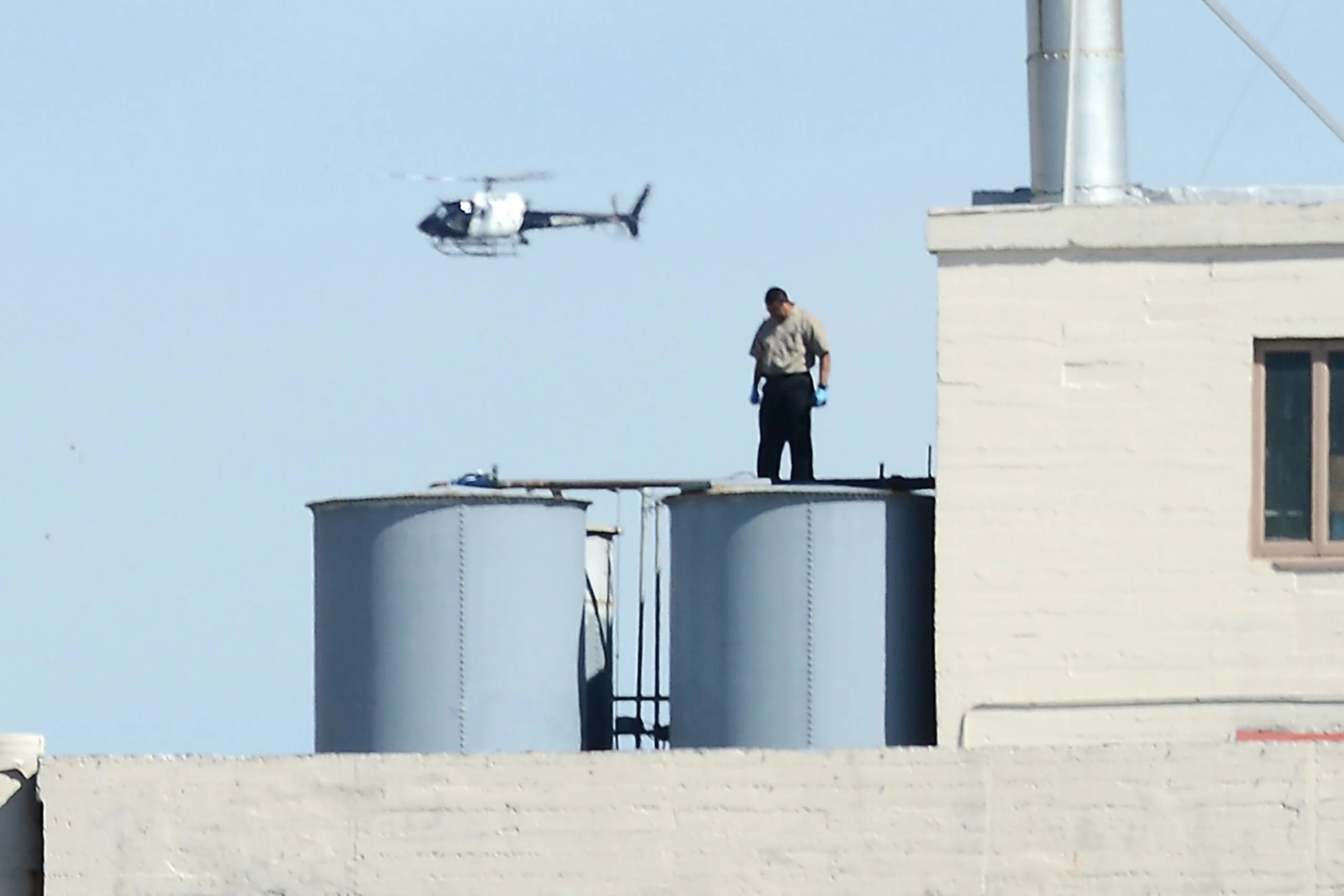 Man on rooftop water tank