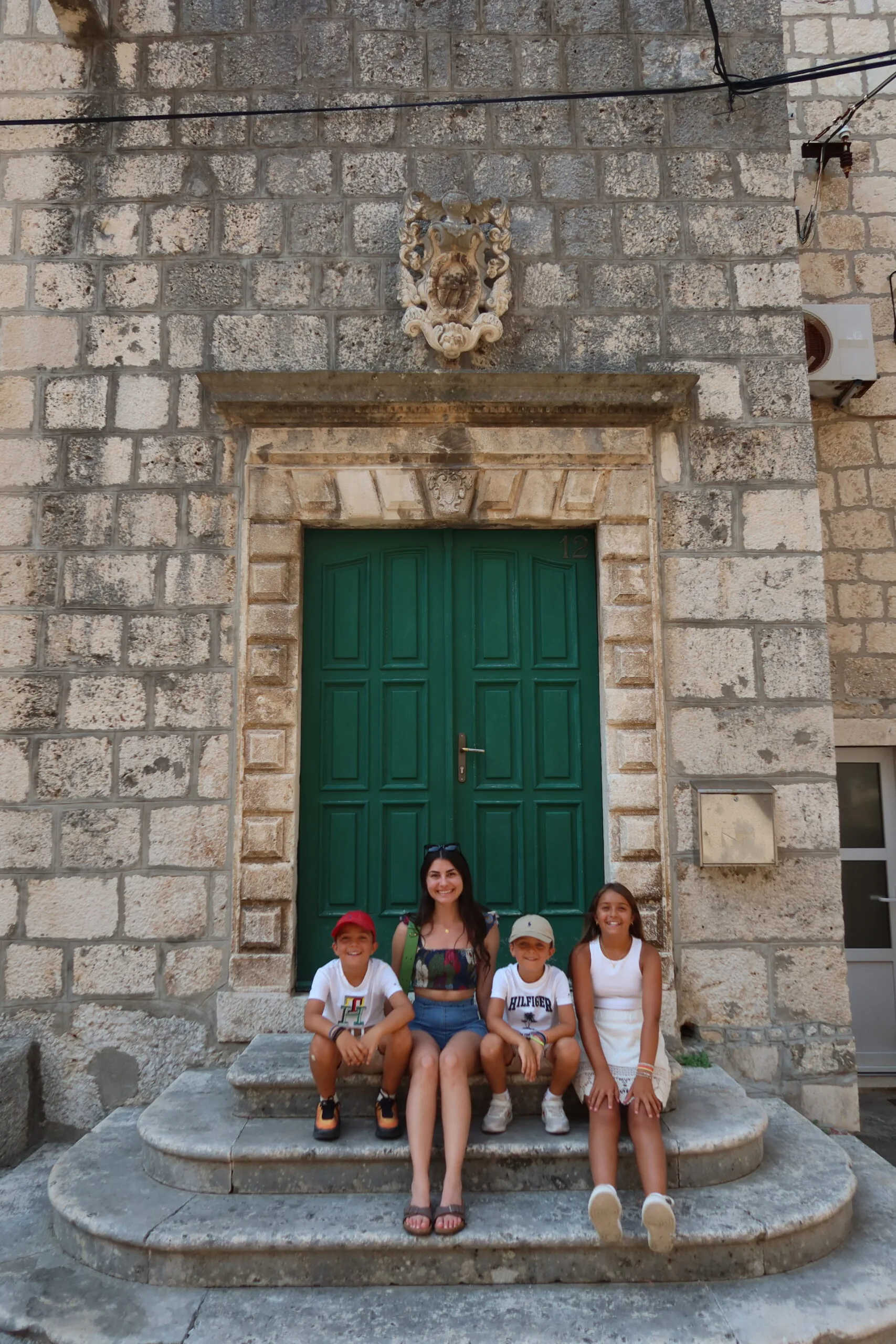 Image of family sitting on steps in Korcula Olt Town