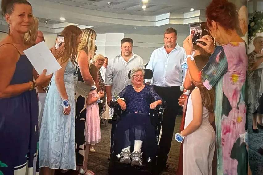 woman rolling down aisle in wheelchair