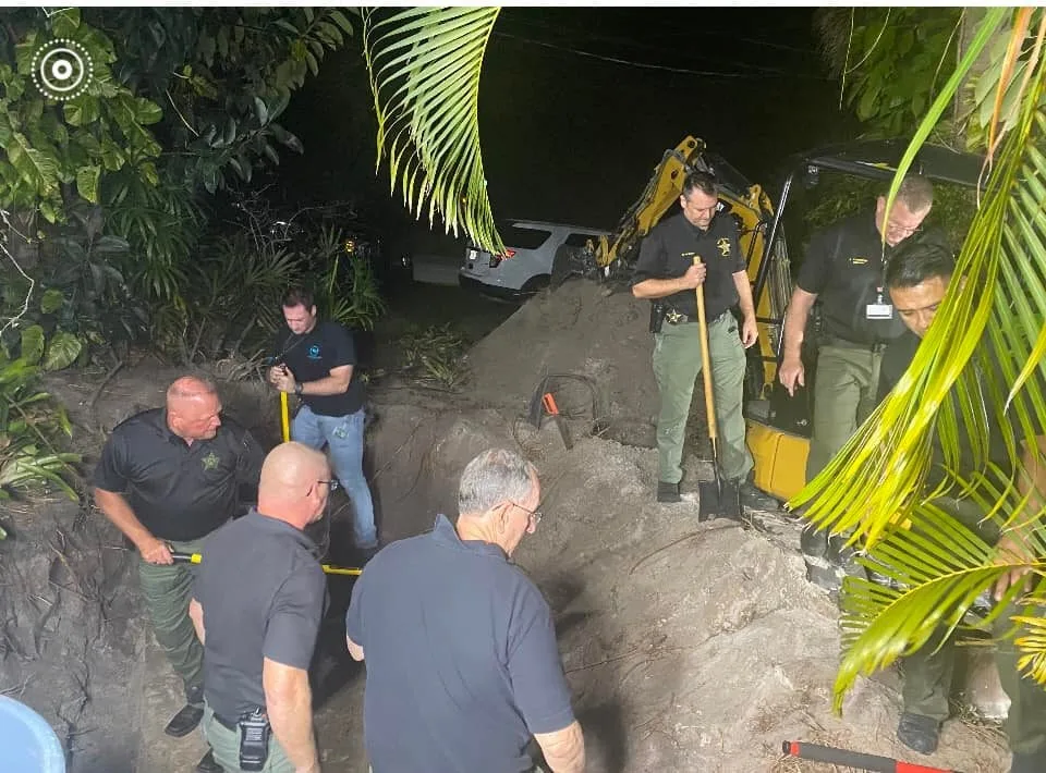 Officers uncovering body in septic tank