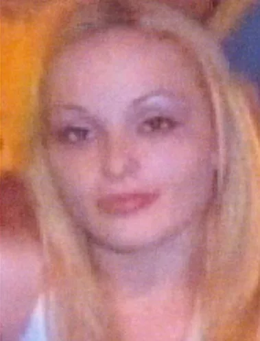 Woman with blonde haor smiling at camera.