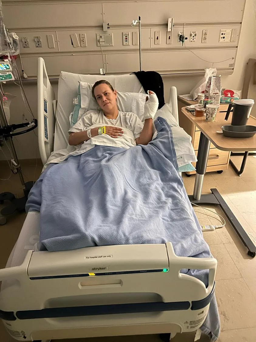 Image of woman recovering in hospital with bandaged hand