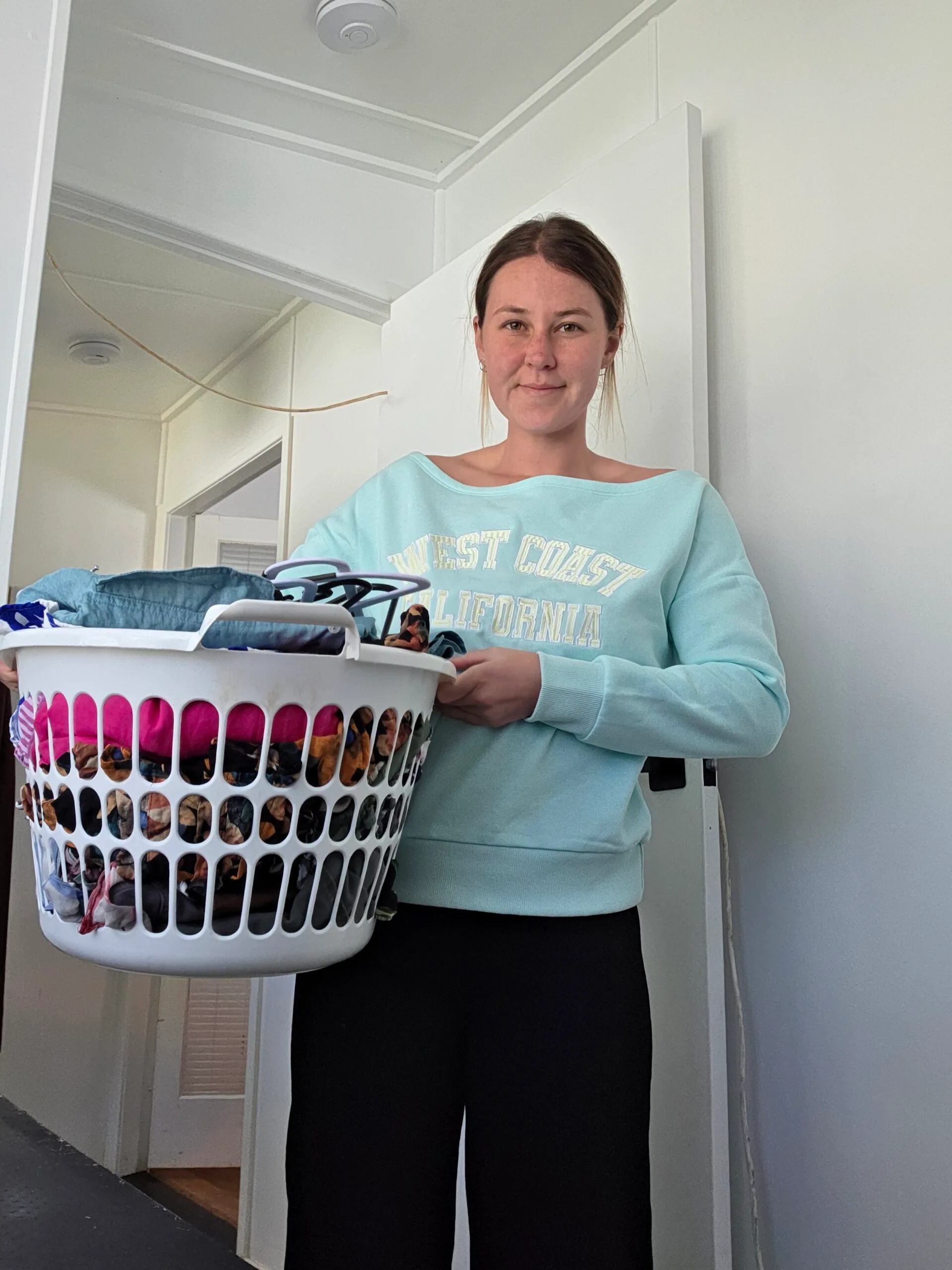 woman holding laundry basket