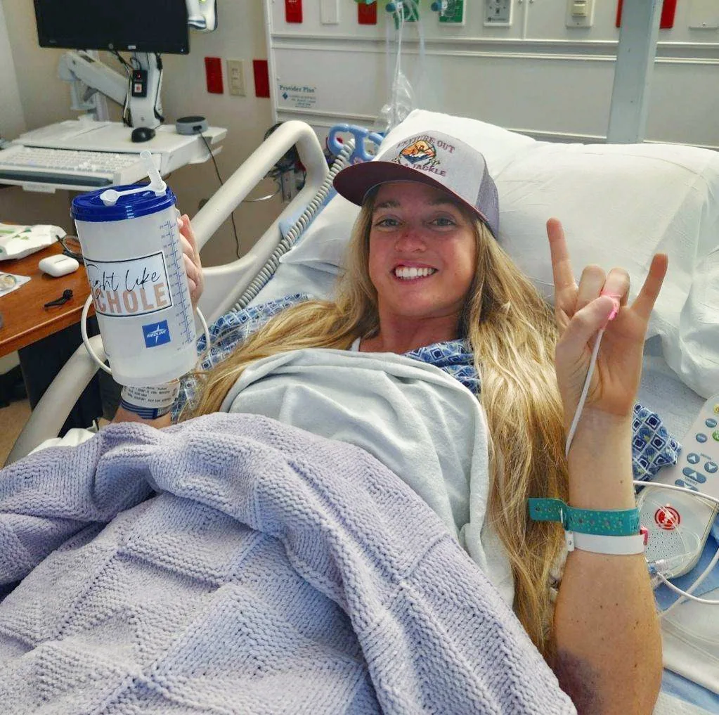 image of woman in hospital with rock on hand sign