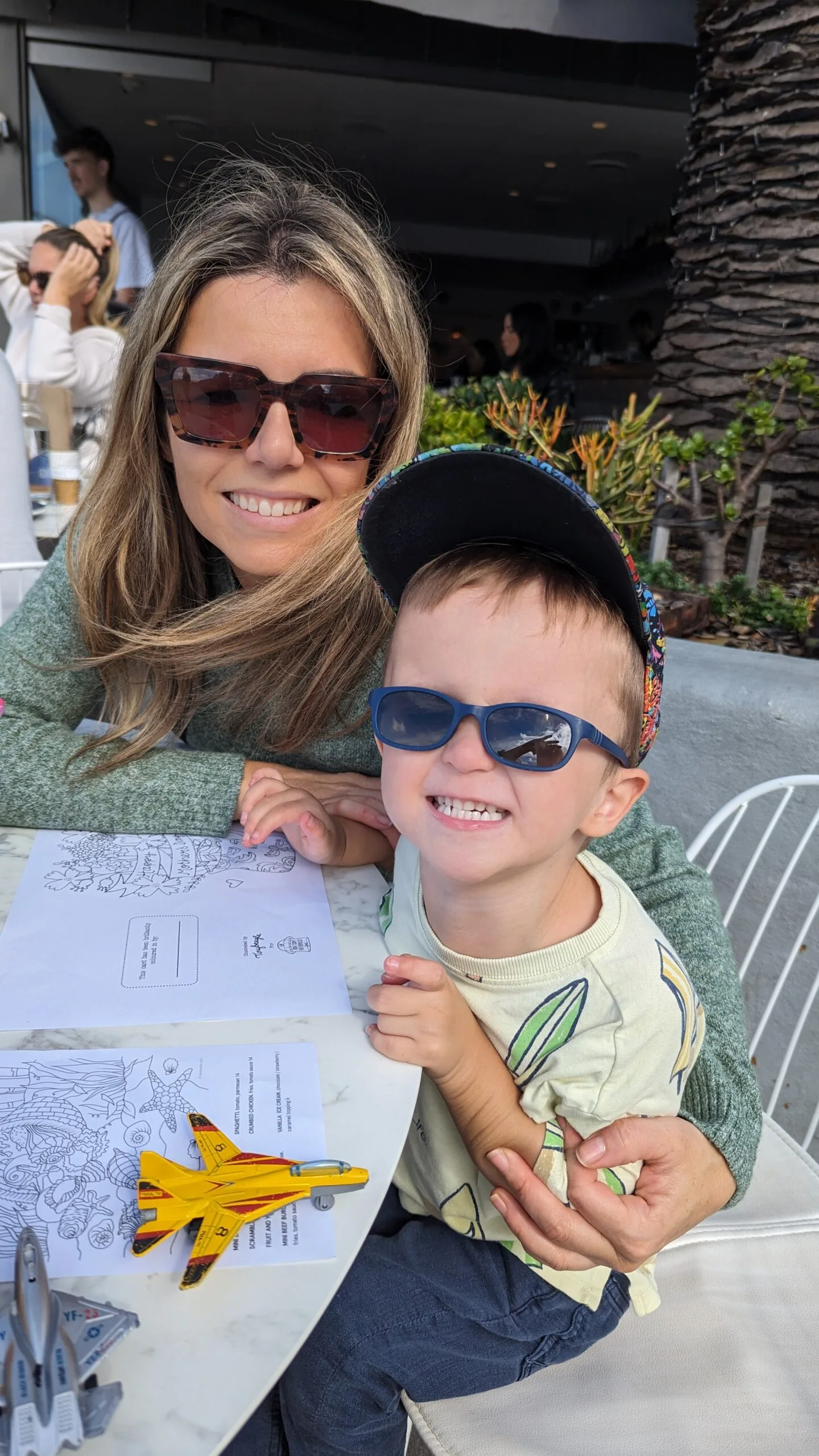 mother and son wearing sunglasses outside