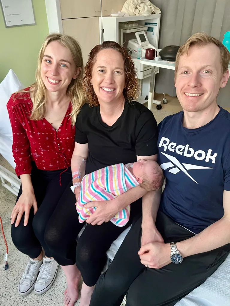 Image of newborn, parents and surrogate