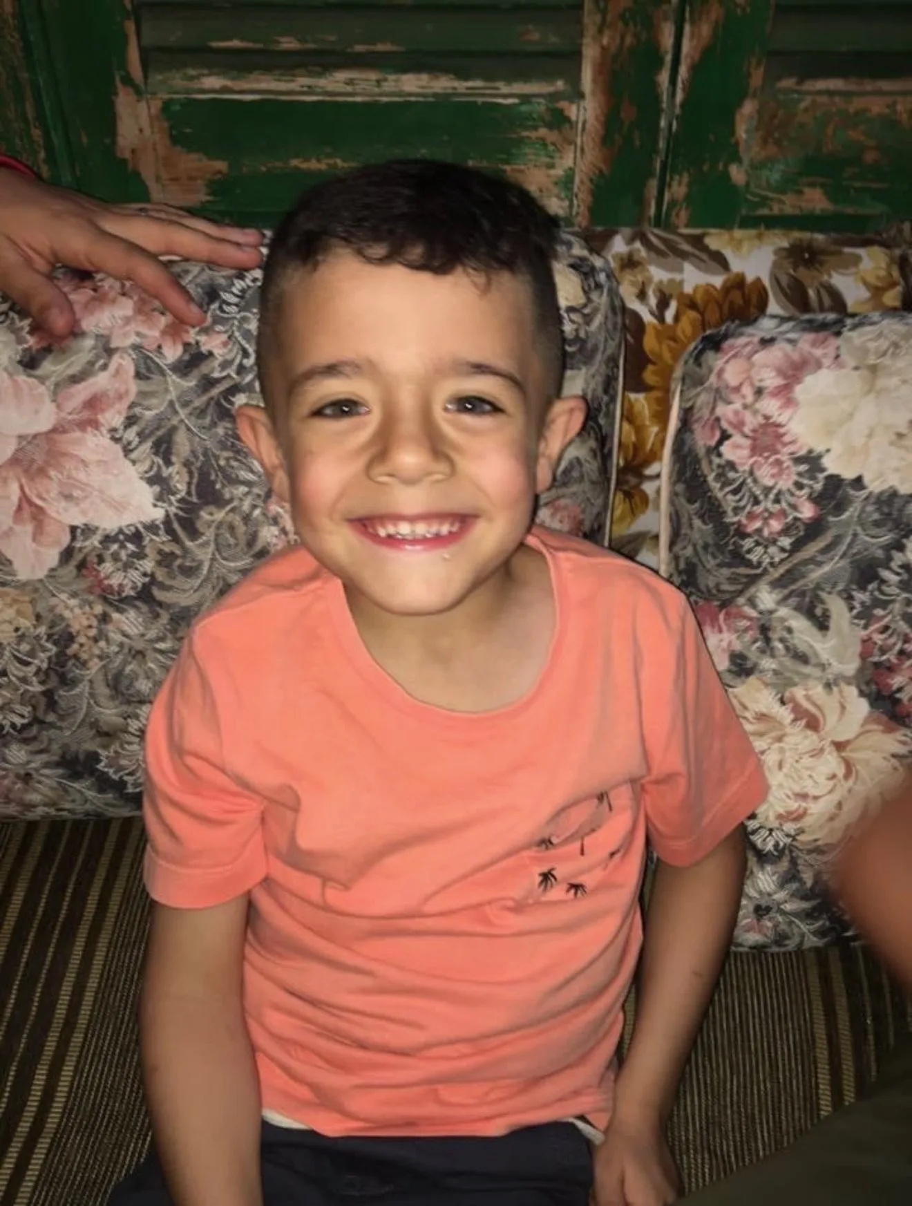 young boy in orange shirt 